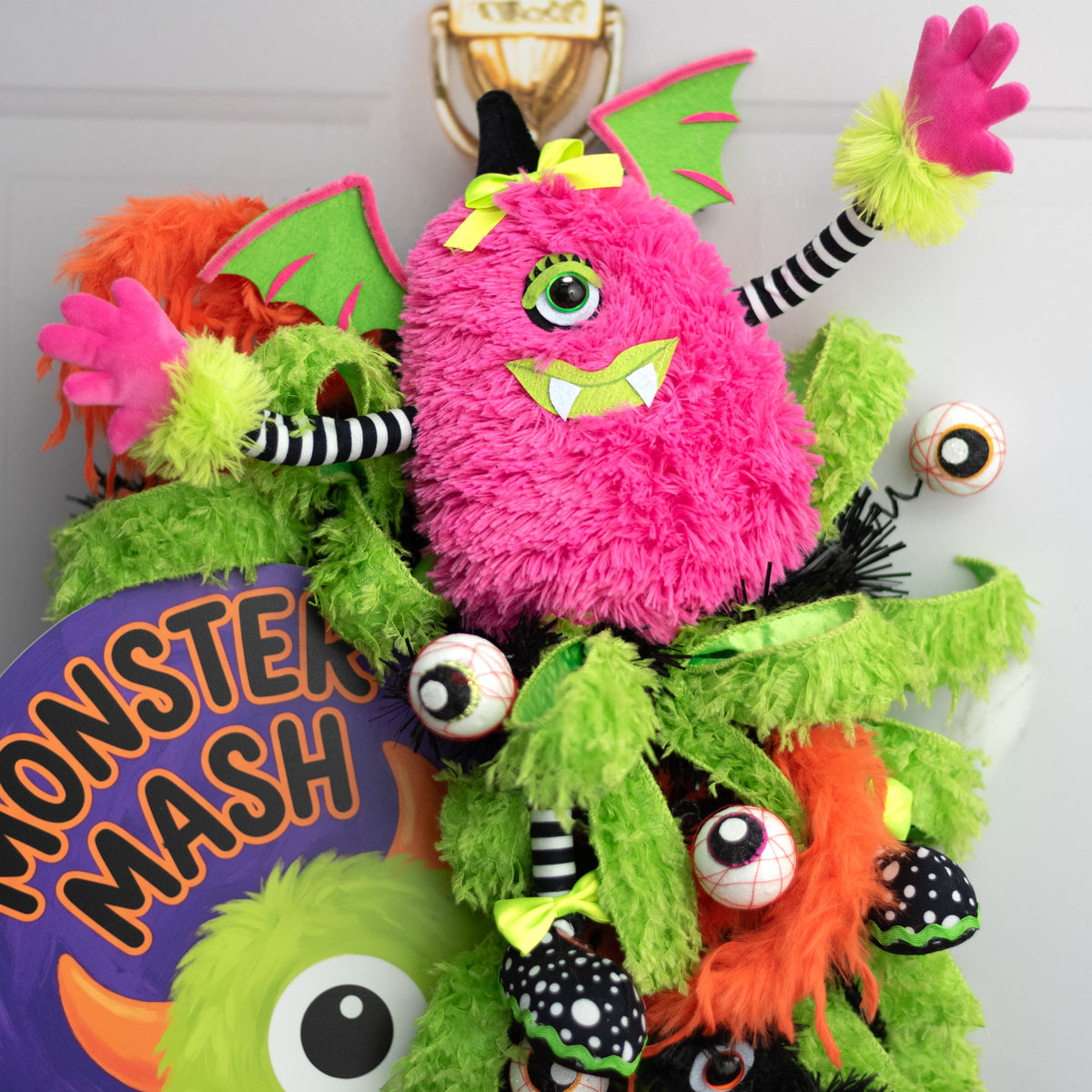 15" Plush Winged Halloween Monster Wreath Decor: Pink Lifestyle Photo