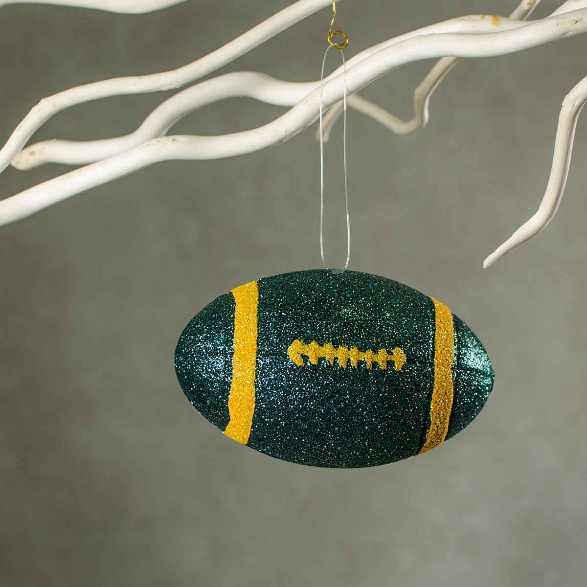 4.5" Metallic Glitter Football Ornament: Green & Yellow Lifestyle Photo